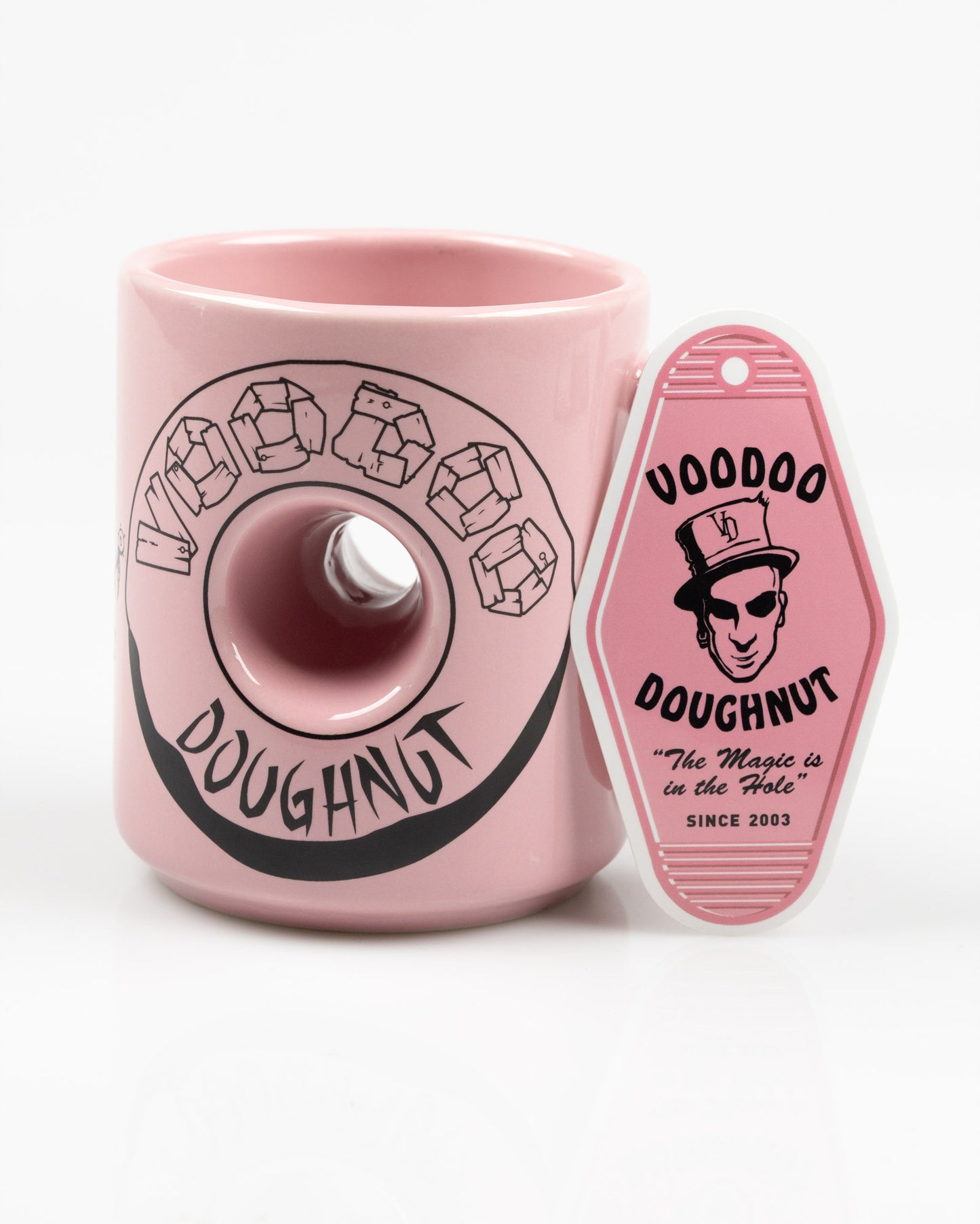 Pink mug with Voodoo Doughnut logo and sticker on a white background