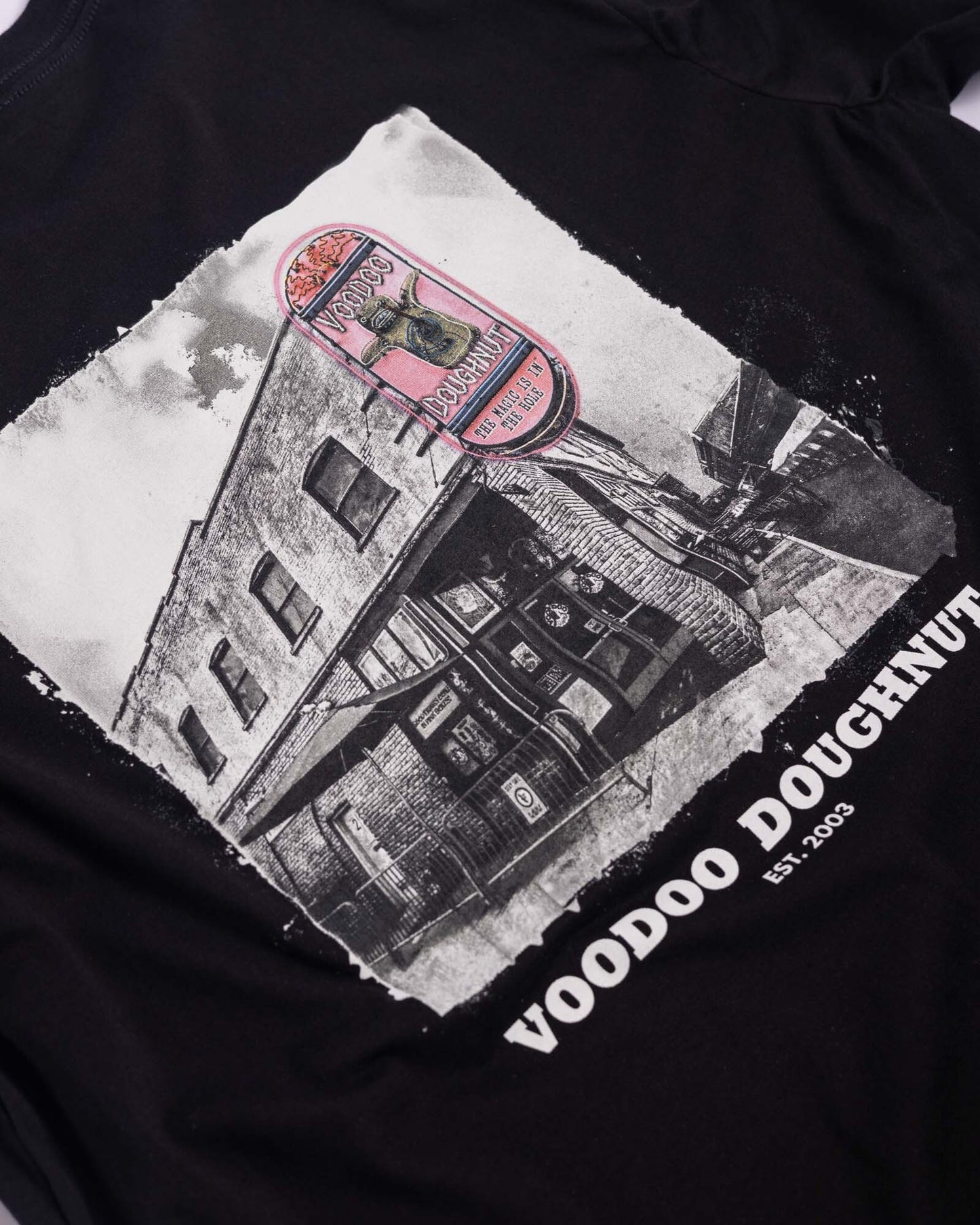 black t-shirt with voodoo old town building graphic on center of shirt