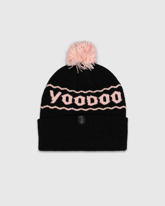 Black beanie with pink pom-pom and 'Voodoo' pattern on a light gray background