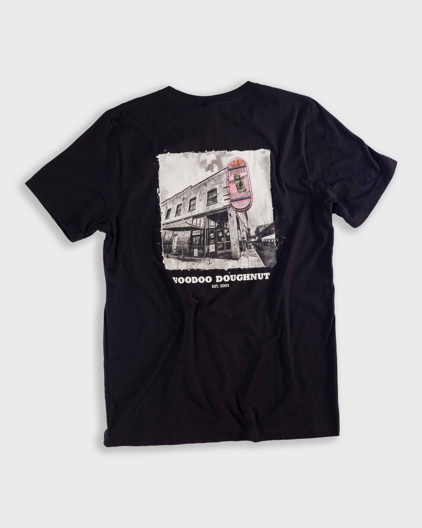 black t-shirt with voodoo old town building graphic on center of shirt